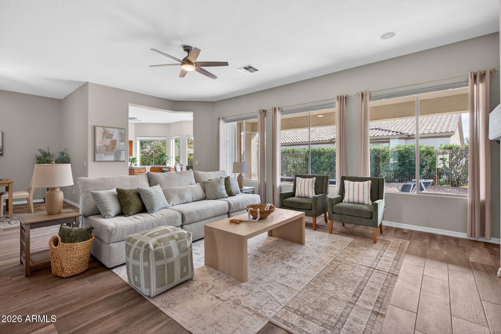 Living room after, professionally staged with sectional, accent chairs, layered styling